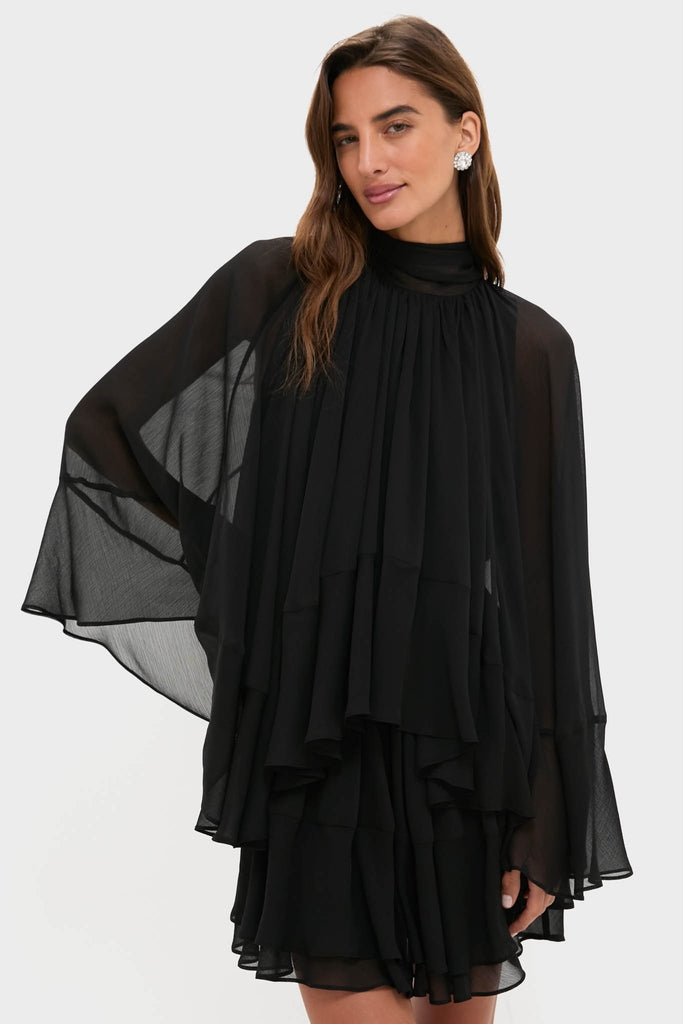 Model wearing the Black Cape Chiffon Mayfield Dress, a classic and effortless high-end piece with flared sleeves and a tiered design, perfect for fun events.